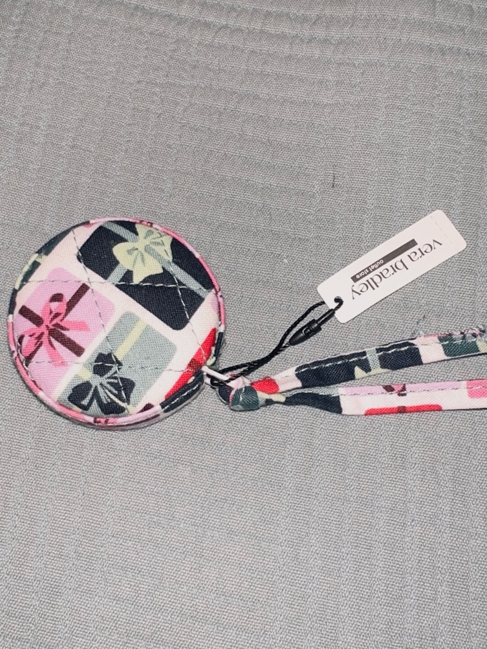 One new Vera Bradley tape measure in the pattern GIFTS APLENTY!